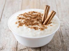 a bowl filled with yogurt and cinnamon sticks