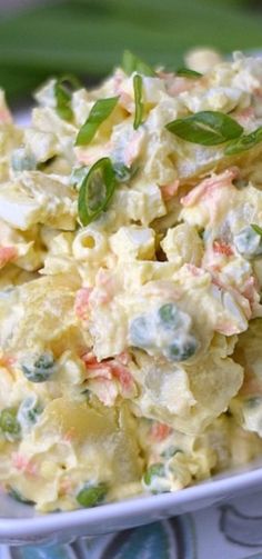 a white bowl filled with potato salad on top of a table