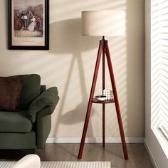 a living room with a green chair and a lamp on the floor next to it