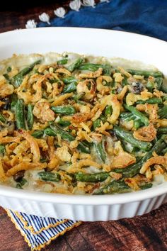 a casserole dish with green beans, onions and bread crumbs in it