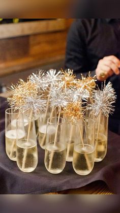 several glasses filled with champagne and gold sprinkles on top of a table