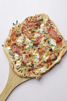 a pizza sitting on top of a wooden spatula