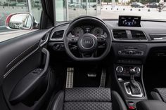 the interior of an audi car with black leather seats and steering wheel, dash lights, and dashboard controls