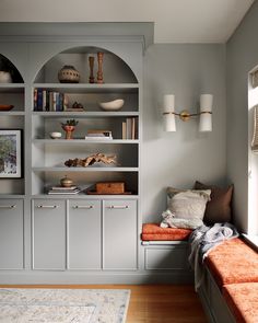 a living room filled with furniture and bookshelves on top of eachother