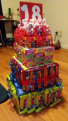 a stack of candy boxes sitting on top of a hard wood floor