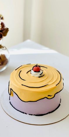 a yellow cake sitting on top of a white table