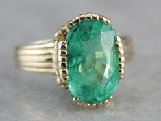 "This vintage emerald ring is a simple, and quite a versatile piece with clean lines and great proportions. This ring is classic and traditional, featuring a solid gold head to hold the stone securely. The beautiful emerald has a shade of green that is just the same as the brightest springtime leaves. Metal: 14K Yellow Gold Gem: Emerald 4.08 Carats Gem Measurements: 12.1 x 8.5 mm, Oval Ring Size: 6 Marks: \"KIMBERLY 14K\" Stamped on the inside band SKU #: 3LWN4FJ2 Each piece has been identified Timeless Bezel-set Emerald Ring For May Birthstone, Timeless Emerald Ring With Bezel Setting For May Birthstone, Timeless Bezel Set Emerald Ring For May Birthstone, Timeless May Birthstone Emerald Ring With Bezel Setting, Elegant 14k Stamped Emerald Ring, Classic Solitaire Diamond Ring For May Birthstone, Classic Emerald Signet Ring With Bezel Setting, Timeless Emerald Signet Ring For Anniversary, Timeless Emerald Rings With Bezel Setting