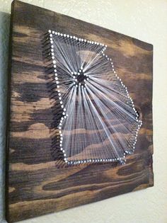 a string art piece is hanging on the wall