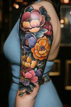 a woman's arm with colorful flowers on it