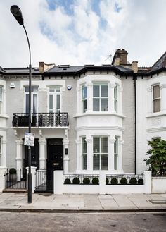 an apartment building with white walls and windows