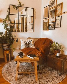 a living room filled with furniture and pictures hanging on the wall above it's coffee table