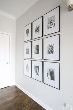 black and white photographs are hung on the wall above a wood flooring area in a home