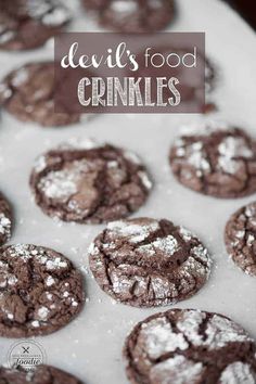 devil's food crinkles on a baking sheet with powdered sugar in the middle