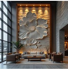 a living room filled with furniture and a large flower on the wall above it's fireplace