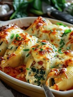 a casserole dish with spinach and cheese in it, ready to be eaten