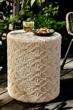 a table that has food on top of it in front of some plants and flowers