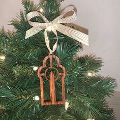 a wooden ornament hanging from the top of a christmas tree