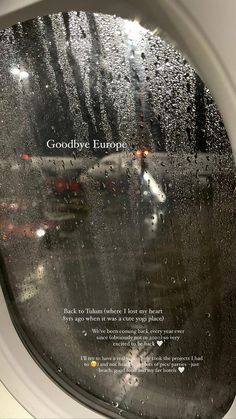 an airplane window with the words goodbye europe written on it and rain drops coming down