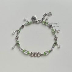 "A sweet handmade anklet ✿ Made with glass beads, glass crystal beads, and metal accents ✿ Silver, fern green, and clear white ✿ The anklet has an additional 1 - 1.5\" of extension chain. ✿ Some beads may be added or removed depending on the length selected" Handmade Green Crystal Bracelets, Bohemian Green Anklets With Tiny Beads, Adjustable Green Anklets With Tiny Beads, Green Adjustable Glass Beaded Bracelets, Dainty Green Hand-strung Beaded Bracelets, Bracelets Green, Stolen Image, Anklet Silver, Handmade Anklets