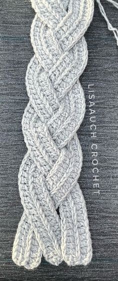 a close up of a white rope on a gray surface with the words lace knitting written across it