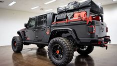 the jeep is parked in the garage with its bed on it's back end