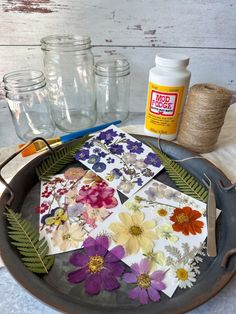 some flowers are sitting in a pan on a table next to twine of twine