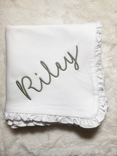 a white pillow with the word smile embroidered on it