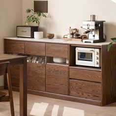 a kitchen area with a microwave, toaster and coffee maker