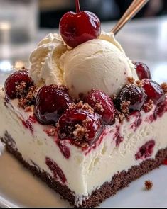 a piece of cake with ice cream and cherries on top