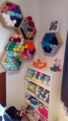 the shelves are filled with different types of yarn