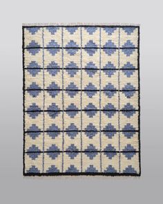 a blue and white rug with squares on the bottom, two rows of smaller squares in the middle