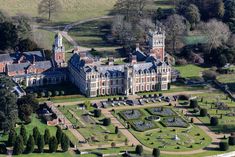 an aerial view of a large building in the middle of a park area with lots of trees