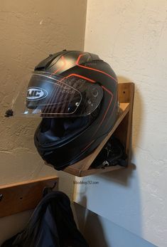 a helmet is sitting on top of a shelf