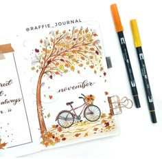 a notepad with an autumn tree and bicycle on it