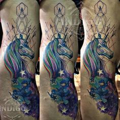 the back of a man's leg with tattoos on it and an image of a unicorn