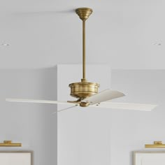 a ceiling fan in a room with white walls