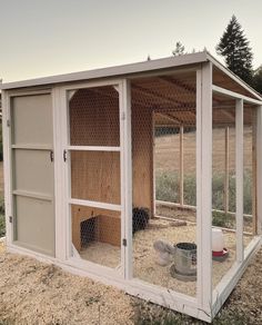 a chicken coop with two chickens in it