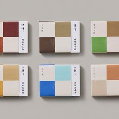 four different color swatches are arranged on a gray surface with chinese characters in the middle