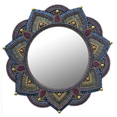 a mirror that is sitting on top of a table with beaded trimmings