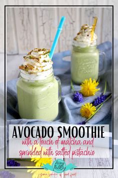 two glasses filled with green smoothie and topped with whipped cream