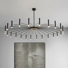 a modern chandelier hangs over a dining room table