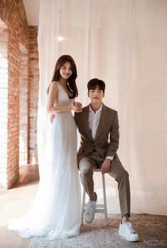 a young man and woman posing for a photo