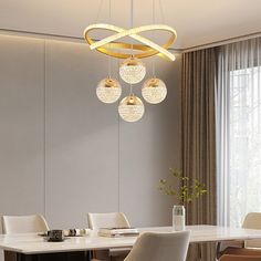 a dining room table with chairs and a chandelier hanging from it's ceiling