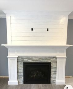 an empty living room with a fireplace and white painted brick surround the space is clean and ready for painting