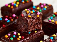 chocolate brownies with colorful sprinkles are stacked on top of each other