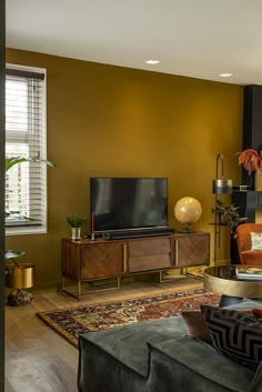 a living room with yellow walls and furniture