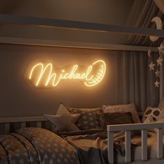 a neon sign that reads michael above a bed