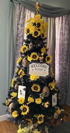 a decorated christmas tree with sunflowers and welcome to our honeymoon sign on it