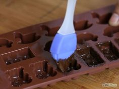 a chocolate mold with a blue spatula in it