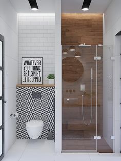 a white bathroom with black and white tiles on the walls